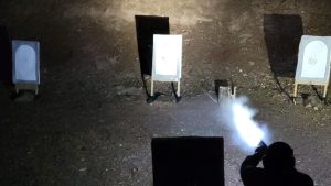 picture of someone shooting at night